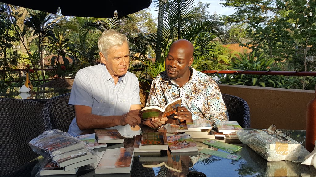 Dickens Zziwa, National Director of SU Uganda, with author Clive Lewis
