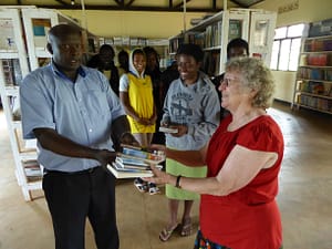 Mary Weeks Millard giving Christian books to Star School, Rwanda