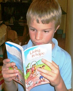 Boy reading Christian book