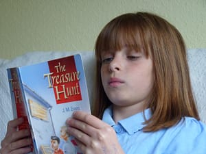 Girl reading The Treasure Hunt book